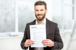 resume jobseeker male holding resume 10 worst CV Mistakes